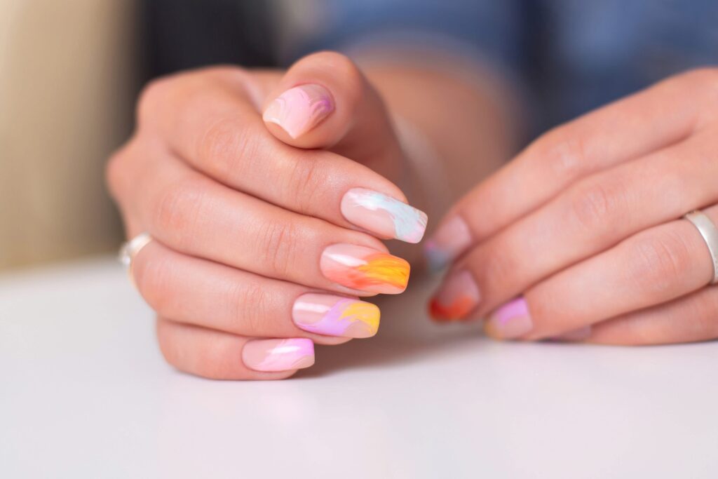 Home 9 beautiful female hands with multicoloured manicure nails pink blue orange gel polish